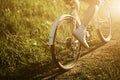 Funny girl driving outdoor. Focus on bicycle. Sunny summer lifestyle concept. Woman in dress and hat in Field with Royalty Free Stock Photo