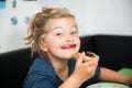 Funny girl eating bread roll with marmelade Royalty Free Stock Photo