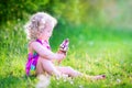 Funny girl eating ice cream in sunny garden Royalty Free Stock Photo