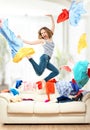 Funny girl with flying clothes jumping at home