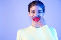 Funny girl with full fake  lips on neon background. Royalty Free Stock Photo