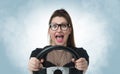 Funny girl in glasses with car wheel and white smoke, auto concept Royalty Free Stock Photo