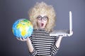 Funny girl in glasses keeping notebook and globe. Royalty Free Stock Photo