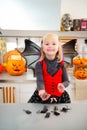 Funny girl in halloween bat costumein with mouse toys Royalty Free Stock Photo