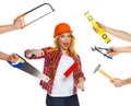 Funny girl in a helmet with different tools is isolated on the w Royalty Free Stock Photo