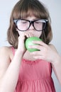 Funny girl with herd sunglasses blowing a balloon Royalty Free Stock Photo