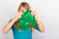 Funny girl holding green slime looks like gunk in front of her face Royalty Free Stock Photo