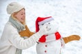 Funny Girl Love winter. Snowman and snow day. Cute snowman at a snowy village. Christmas winter poeple. Winter Royalty Free Stock Photo