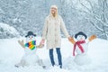 Funny Girl Love winter. Winter portrait of young woman in the winter snowy scenery. Cute girl making snowman on snowy Royalty Free Stock Photo