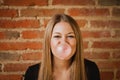 Funny girl making a pomp with a bubble gum Royalty Free Stock Photo