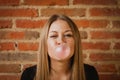 Funny girl making a pomp with a bubble gum Royalty Free Stock Photo