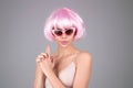 Funny girl with pink wig. Youth and skin care concept. Photo of sensual model isolated on studio background. Close up Royalty Free Stock Photo