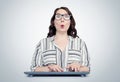 Funny girl programmer in glasses with keyboard in front of computer Royalty Free Stock Photo