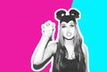 Funny girl represents a small cat or mouse. Woman with a bright makeup hairstyle and night dress mouse ears having fun Royalty Free Stock Photo