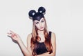 Funny girl show peace sigh represents a small cat or mouse. Woman with a bright makeup hairstyle and night dress mouse ears having Royalty Free Stock Photo