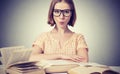 Funny girl student with glasses reading books