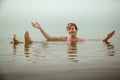 Funny girl swims in water of Dead Sea in Jordan and fog Royalty Free Stock Photo