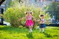Funny girls walking on the lawn with her mother. Sisters play together with mom. maternal care. happy family
