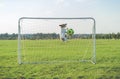 Funny goalkeeper saving goal catching football soccer ball Royalty Free Stock Photo