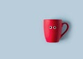 Funny googly eyes red cup flat lay on blue background
