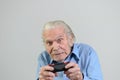 Funny grandfather playing a video game on console Royalty Free Stock Photo