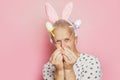 funny gray-haired elderly pensioner man with bunny ears on his head and easter decorative eggs in his hands Royalty Free Stock Photo