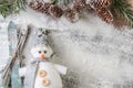 Funny gray and white snowman with skis