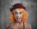 Funny Grimace clown girl girl with tongue outside Royalty Free Stock Photo