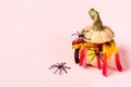 Funny Halloween decorations. Marmalade worms and spiders climb out of ceramic pumpkin