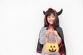 Funny Halloween Kid Concept, little cute girl with costume Halloween ghost scary he holding orange pumpkin ghost on hand, on white Royalty Free Stock Photo