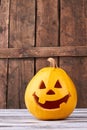 Funny Halloween pumpkin on wood background. Royalty Free Stock Photo