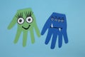 Funny hand shaped monsters on light blue background, flat lay. Halloween decoration Royalty Free Stock Photo