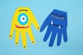 Funny hand shaped monsters on light blue background, flat lay. Halloween decoration Royalty Free Stock Photo