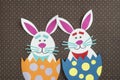 Funny handmade cartoon rabbits placed inside eggs with copyspace