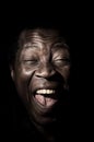 Funny handsome african black man studio portrait.