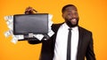 Funny handsome afro-american businessman showing handbag with dollar cash, money