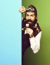 Funny handsome bearded pilot on blue green studio background Royalty Free Stock Photo