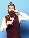 Funny handsome bearded pilot on blue studio background Royalty Free Stock Photo