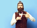 Funny handsome bearded pilot on blue studio background Royalty Free Stock Photo