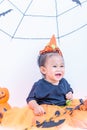 Funny happy baby girl in Halloween costume with pumpkin Jack Royalty Free Stock Photo
