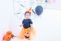 Funny happy baby girl in Halloween costume with pumpkin Jack Royalty Free Stock Photo