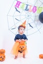 Funny happy baby girl in Halloween costume with pumpkin Jack Royalty Free Stock Photo