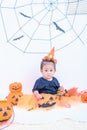 Funny happy baby girl in Halloween costume with pumpkin Jack Royalty Free Stock Photo