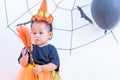 Funny happy baby girl in Halloween costume with pumpkin Jack Royalty Free Stock Photo