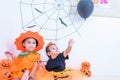 Funny happy brethren baby girl and kid boy in Halloween costume with pumpkin Jack Royalty Free Stock Photo