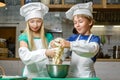 Funny happy chef boy width girl cooking at Royalty Free Stock Photo