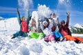 Funny happy friends with snowboards throwing snow Royalty Free Stock Photo