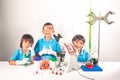 Funny and happy kids in science leaning on white background
