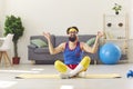 Funny happy man in retro sportswear sitting in easy yoga pose and learning to meditate