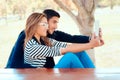 Cute Couple Using PC Tablet Outdoors in Nature
